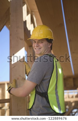 Happy young worker at construction site