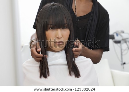 Asian woman getting a new haircut at beauty salon