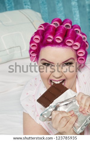 Young woman eating chocolate bar