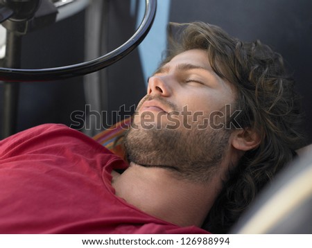 Caucasian man asleep in bus on a road trip