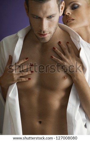 Woman seducing man isolated over purple background
