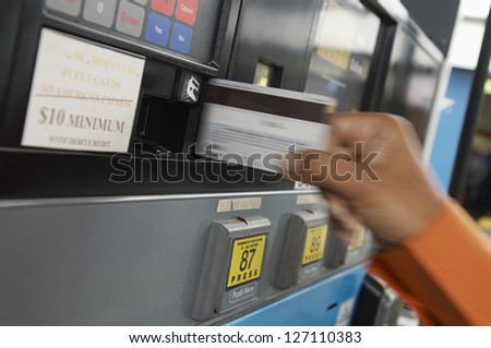 Close-up of a woman\'s hand doing transaction at petrol station