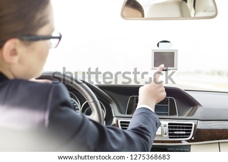 Executive using GPS navigation inside car