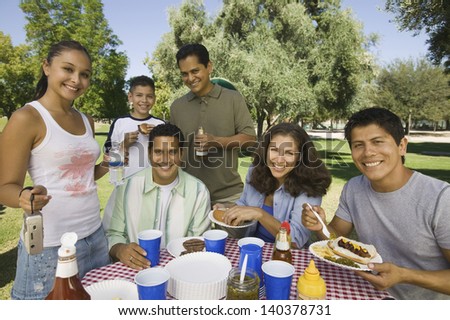 Boy with his happy family having food on a picnic