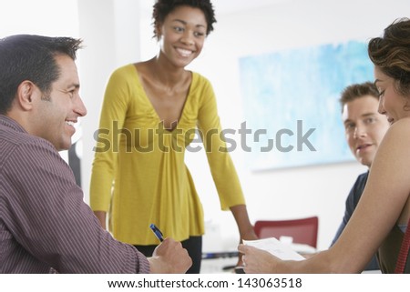 African American businesswoman having discussion with colleagues in office