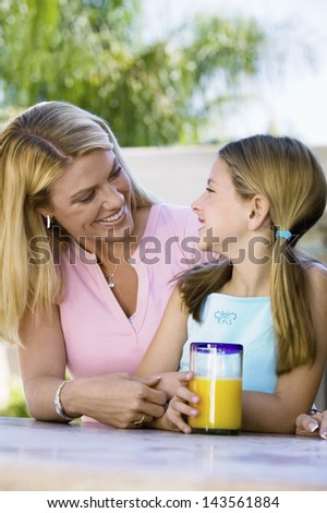 Mother and Daughter Sitting on Patio