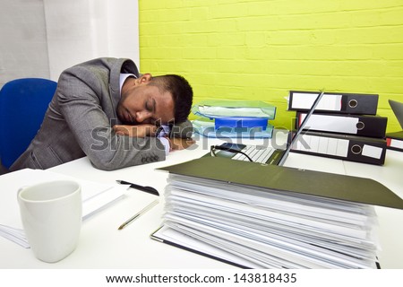 Indian businessman asleep at his desk
