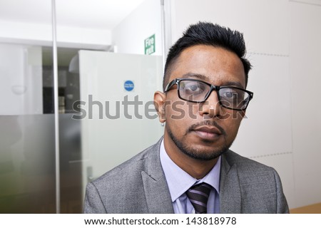 Close-up portrait of Indian Businessman wearing glasses with beard