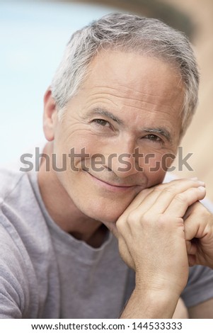 Closeup portrait of middle aged man relaxing by pool