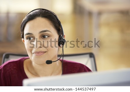 Portrait Of Beautiful Young Asian Businesswoman Wearing Headset In Call Center