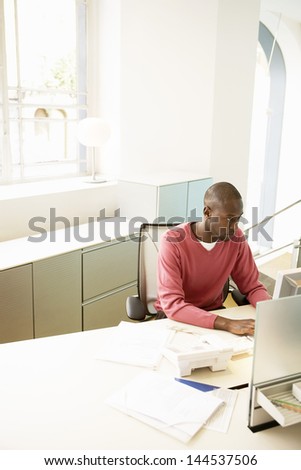 Young African American businessman working on computer at desk