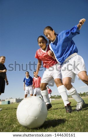 Low angle view of girls playing soccer