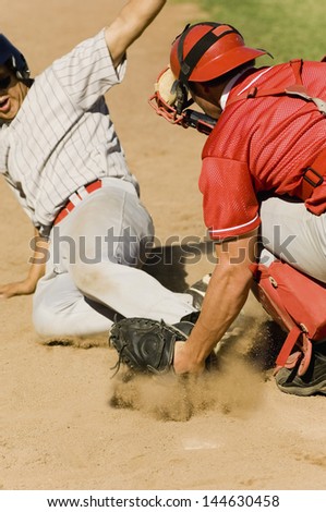 Closeup of two baseball players at home base