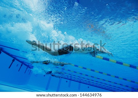 Low angle view of young men swimming underwater