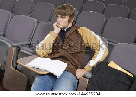 Male University student sitting in lecture hall