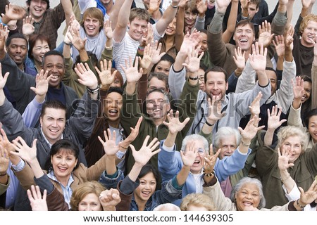 High angle view of group of happy multiethnic people raising hands together