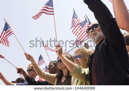 Multiethnic group of people with American flag during a rally