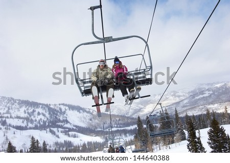 Low angle view of a couple in skies sitting on ski lift