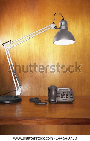 Lamp and telephone on desk