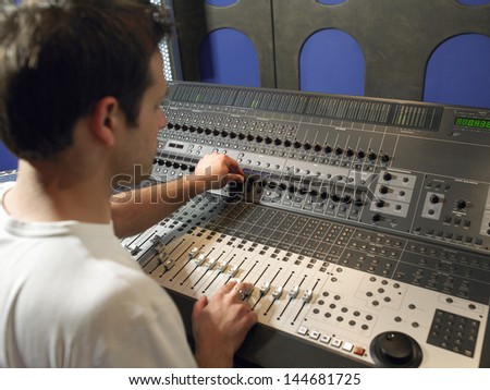 Young Male Sound Technician In Recording Studio