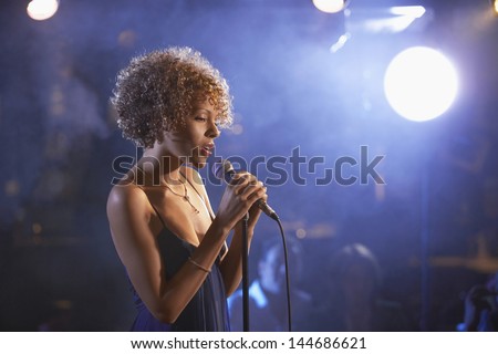 Profile shot of a female jazz singer on stage