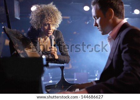 Female jazz singer and pianist on stage