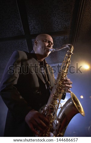 Low angle view of a musician playing saxophone in the jazz club