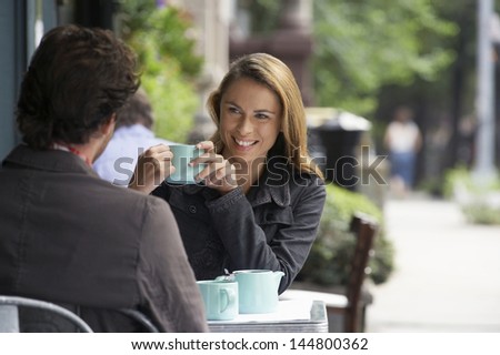 Couple sitting at sidewalk cafe