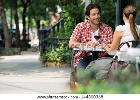 Couple Drinking Wine At Sidewalk Cafe