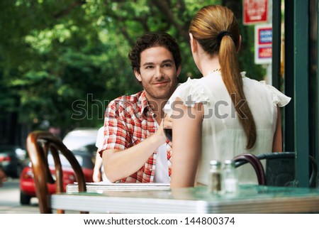 Couple sitting at sidewalk cafe