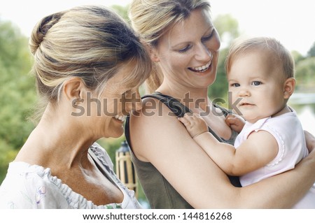 Grandmother With Mother And Daughter Against The Lake