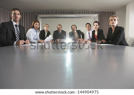 Portrait of multiethnic business people watching presentation in conference room