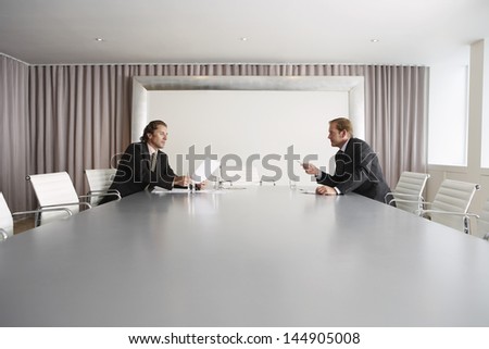 Two businessmen having a discussion in conference room