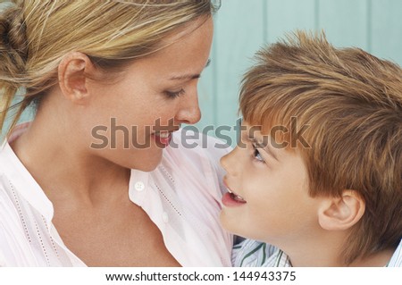Closeup of mother and son lovingly looking at each other