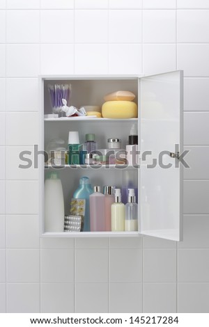 Various cosmetics and bath products in bathroom cabinet
