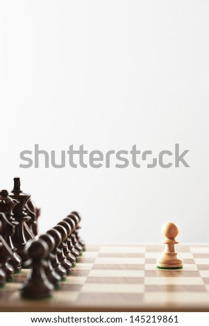Chess game single white piece in front of black pieces