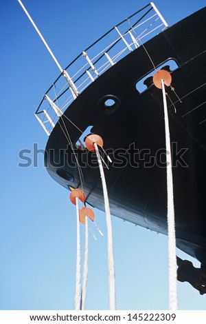 Ropes hanging from ship\'s bow close-up