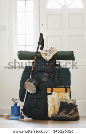 Backpack and camping equipment in hallway