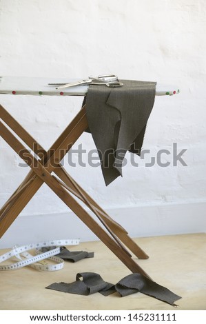 Cut pieces of fabric on ironing board