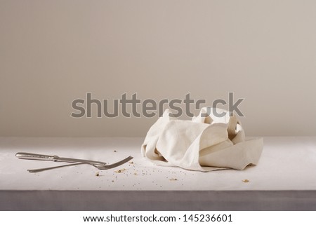 Dish cloth cutlery and crumbs on table
