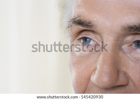 Detail portrait shot of a senior man\'s face against blurred background