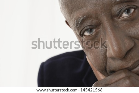 Closeup portrait of an African American senior businessman against white background