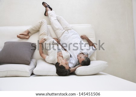 Directly above shot loving couple relaxing on sofa
