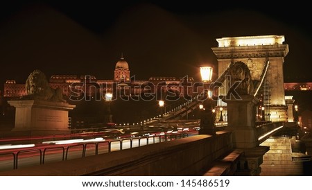 Night cityscape of the Chain bridge across the river Danube with the Buda castle in the background in the Hungarian capital Budapest