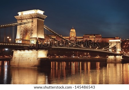 Dusk cityscape of the Chain bridge across the river Danube with the Buda castle in the background in the Hungarian capital Budapest