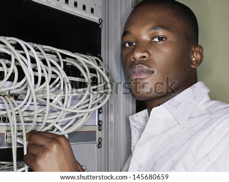 Portrait of network engineer working in server room