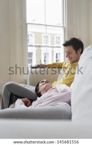 Young relaxed couple on sofa at home