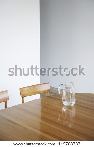 Water jar on wooden dining table at home