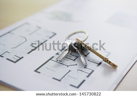 Closeup of keys on blueprint of new home