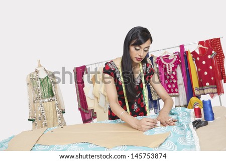 Indian female clothing designer working in design studio